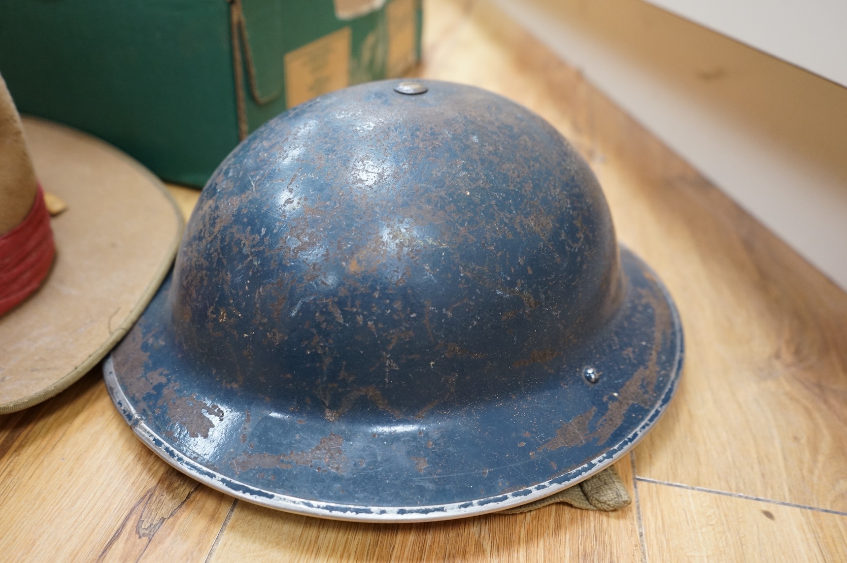 A collection of military related items, including an instrument panel from a WWII RAF Lancaster bomber aircraft, a Bosun’s whistle, a Heckler and Koch ‘bullet’ pen, a WWII tin hat (possibly police), a pith helmet, an Aus